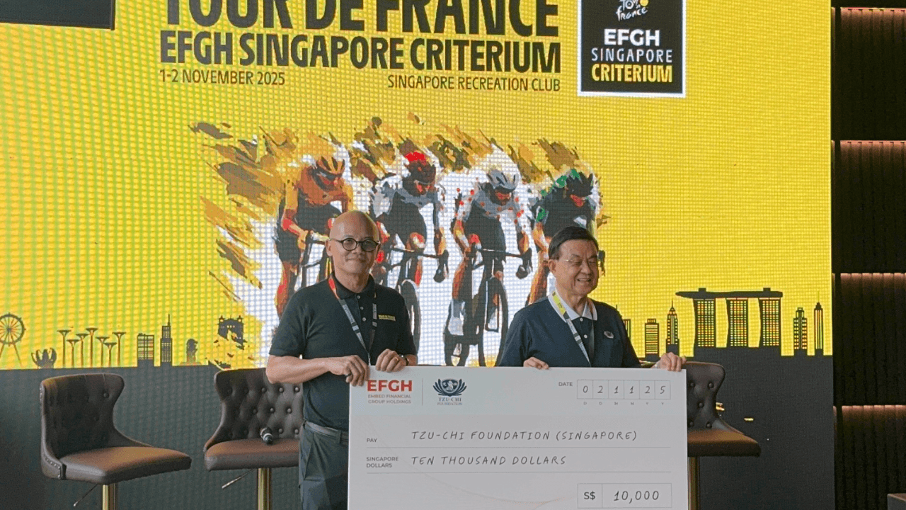 Dennis Ng, Executive Chairman of EFGH, presenting a $10,000 donation cheque to Low Swee Seh, CEO of Tzu Chi Foundation (Singapore), during the Tour de France EFGH Singapore Criterium event.